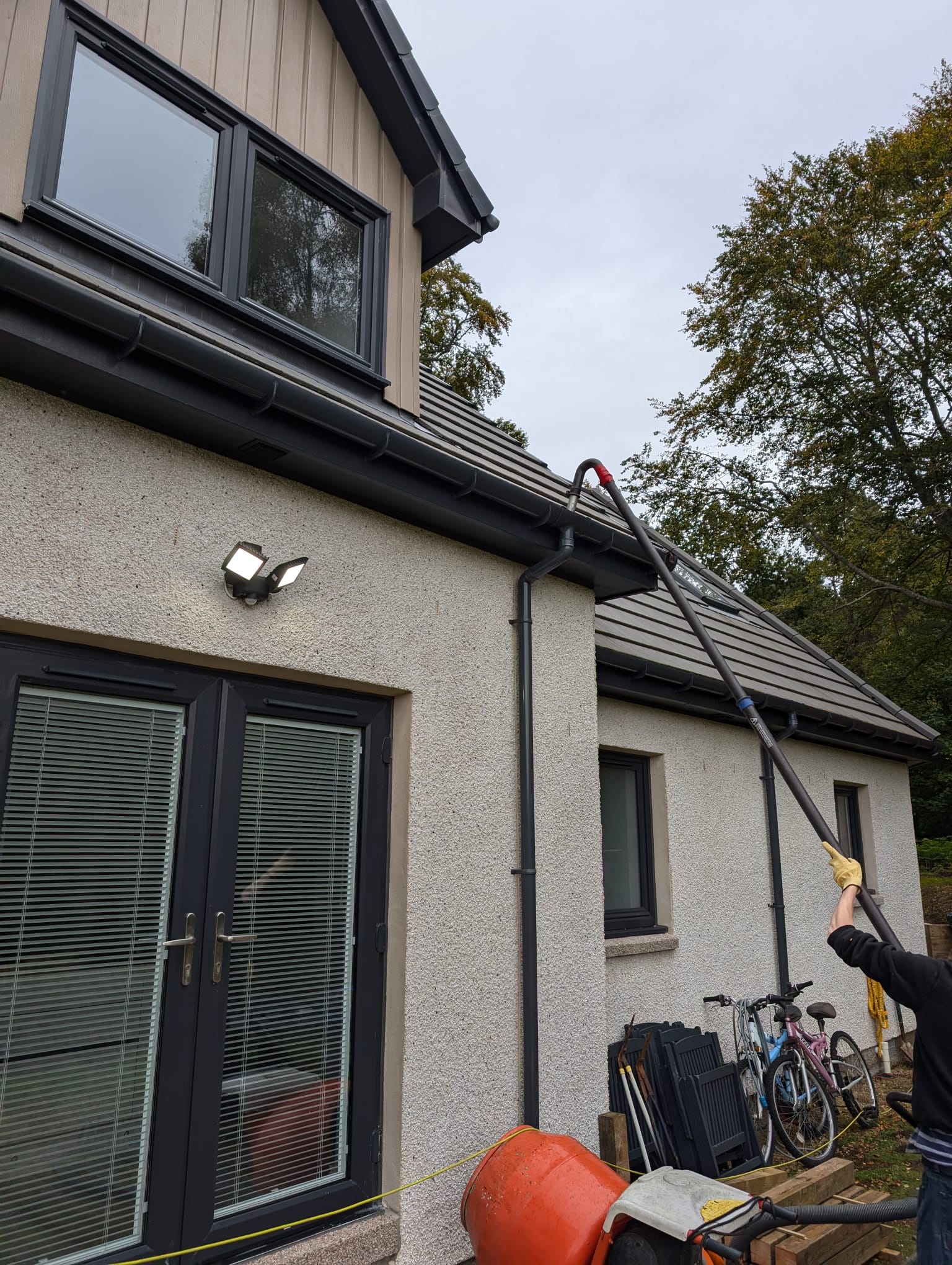 Residential gutter cleaning service - professional ladder work